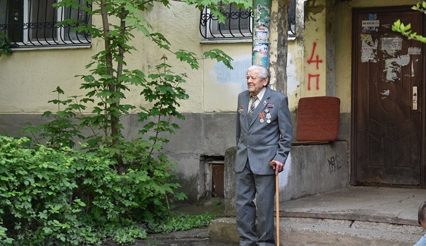 Ветеран слушает концерт у своего дома в Симферополе